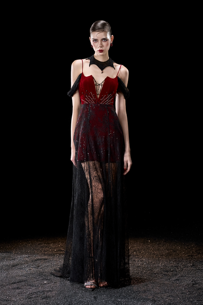 Model wearing a red and black dress with sheer panels