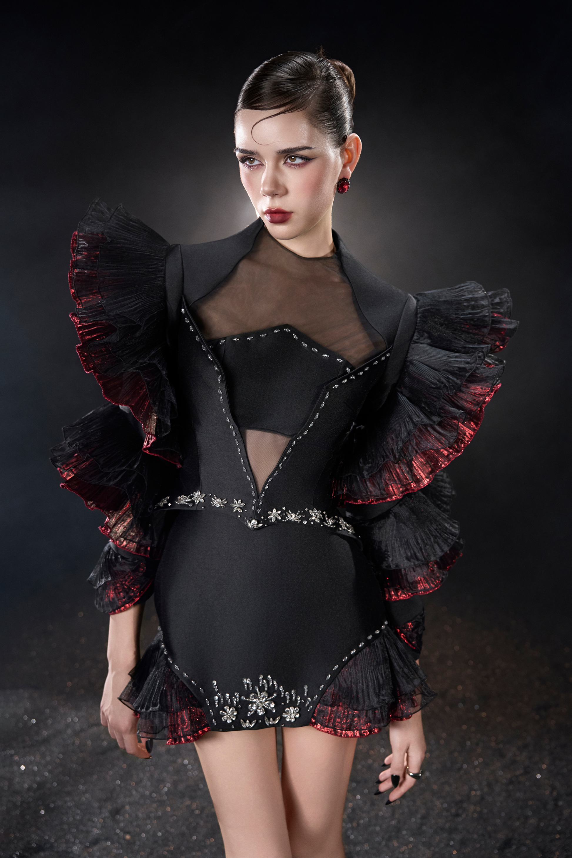 Model wearing a black and red outfit with ruffled sleeves