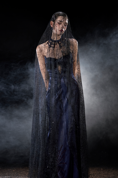 Person wearing a dark blue dress and veil 