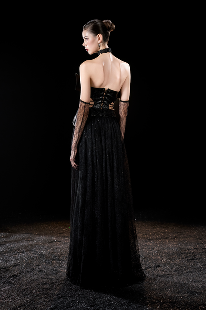Woman wearing a black evening gown with lace details