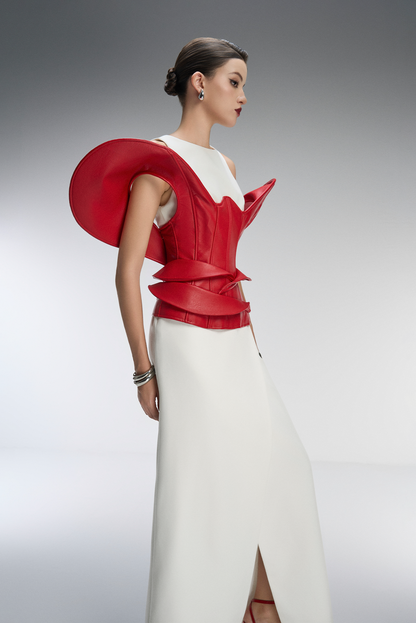 Model wearing a red and white outfit on a gray background