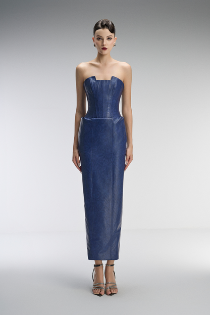 Woman wearing a strapless blue dress on a gray background