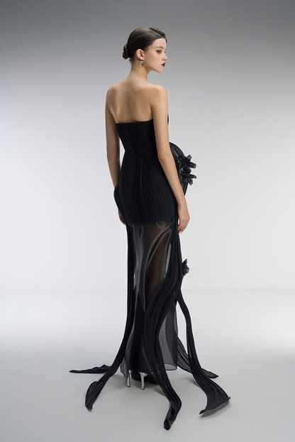A black strapless gown with sheer panels