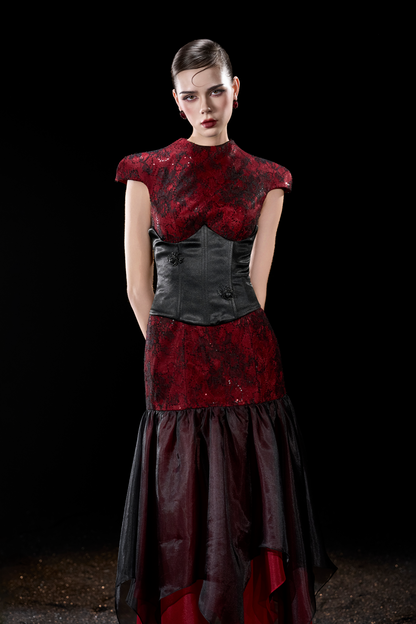 Model wearing a red and black dress 