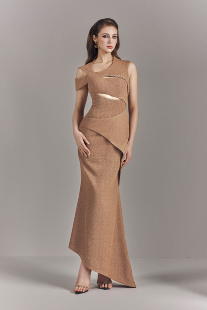 Woman wearing a brown dress with cut-out design on a gray background