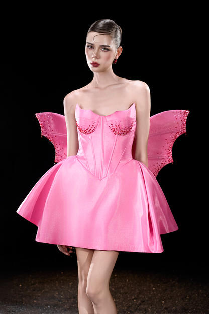 Model wearing a pink fairy costume with wings