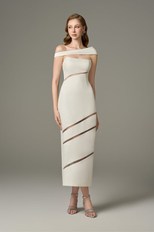 A full-length shot of a woman modeling a serene white off-shoulder, one-sleeve maxi dress with cut-out details and sheer horizontal stripes on the skirt.