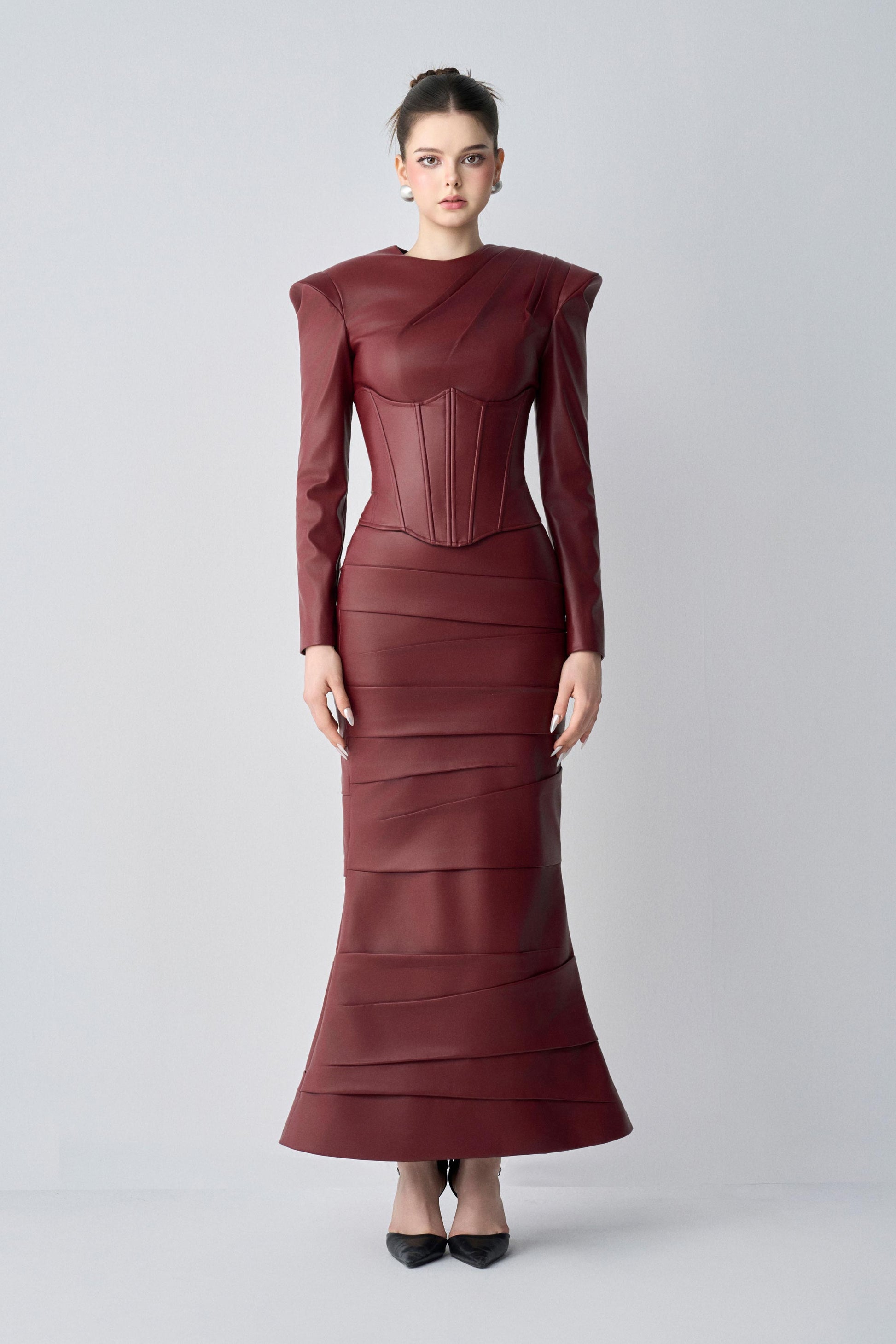 Maroon dress worn by a model on a light gray background