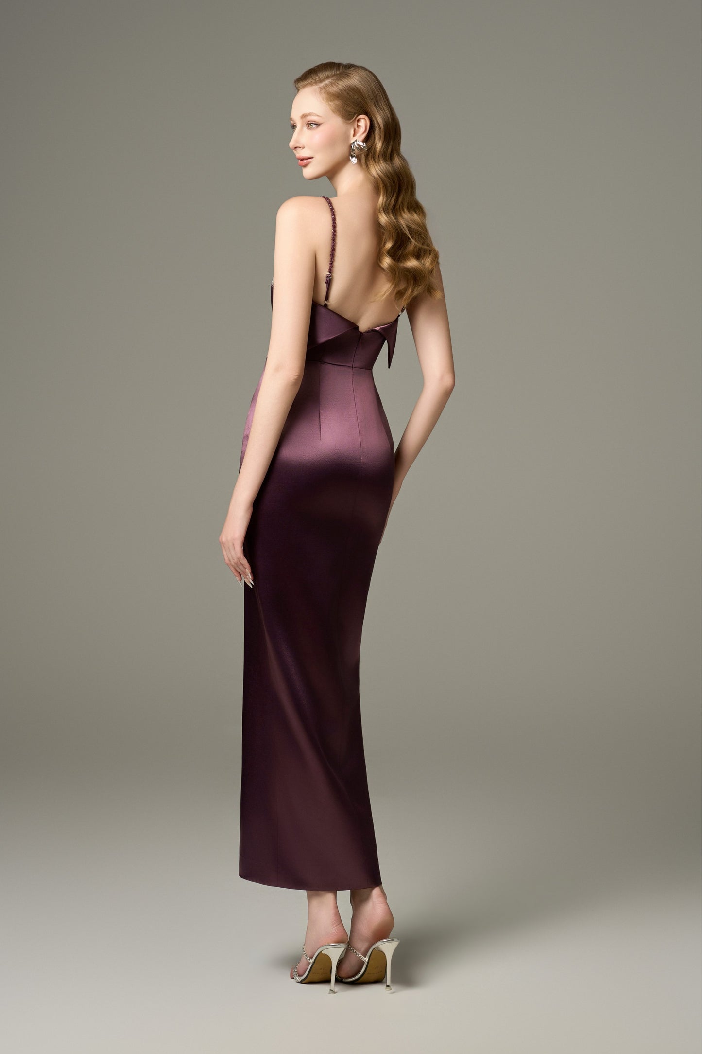 A back view of a Diana purple bodycon Tencel silk maxi dress, showcasing its spaghetti straps, sleeveless design, and a folded collar detail at the back.