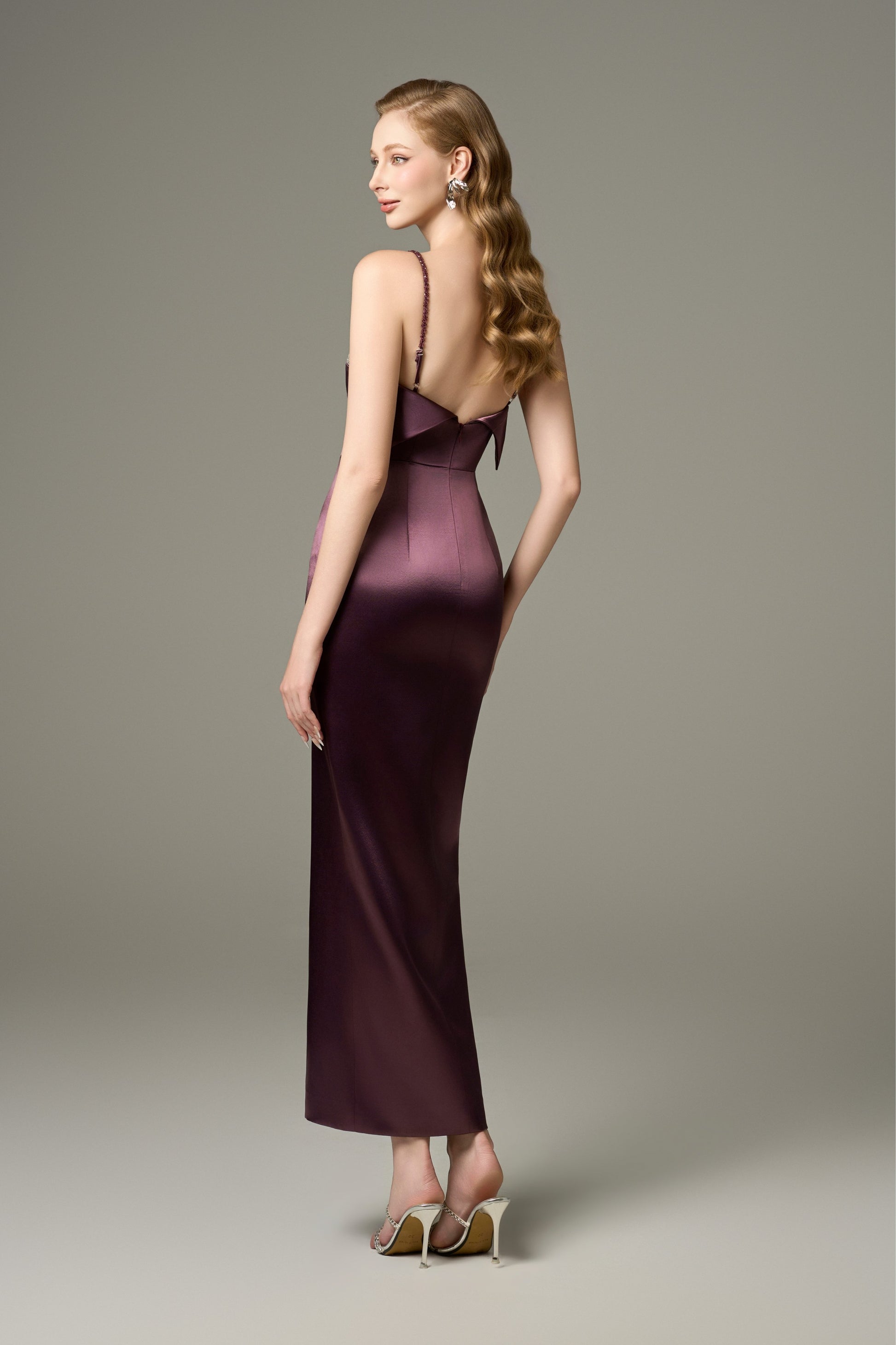 A back view of a Diana purple bodycon Tencel silk maxi dress, showcasing its spaghetti straps, sleeveless design, and a folded collar detail at the back.
