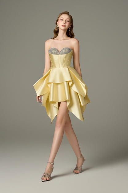 A full-length front view of a Soleil yellow bodycon mini dress with a sweetheart neckline adorned with handcrafted crystal embellishments, a corset bodice, and a distinctive multi-layered, asymmetrical hem.