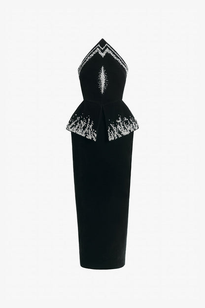 Black evening dress in velvet with a peplum and form-fitting skirt.