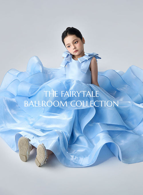 Young girl in a blue ball gown with 'The Fairytale Ballroom Collection' text.