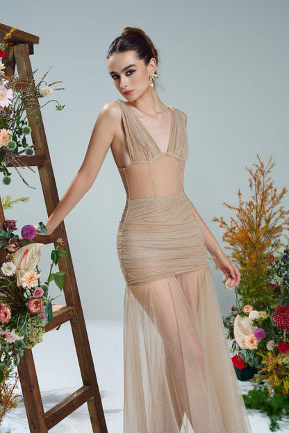 the beige evening dress in shimmering fabric, featuring a sheer, flowing skirt, cut-outs.