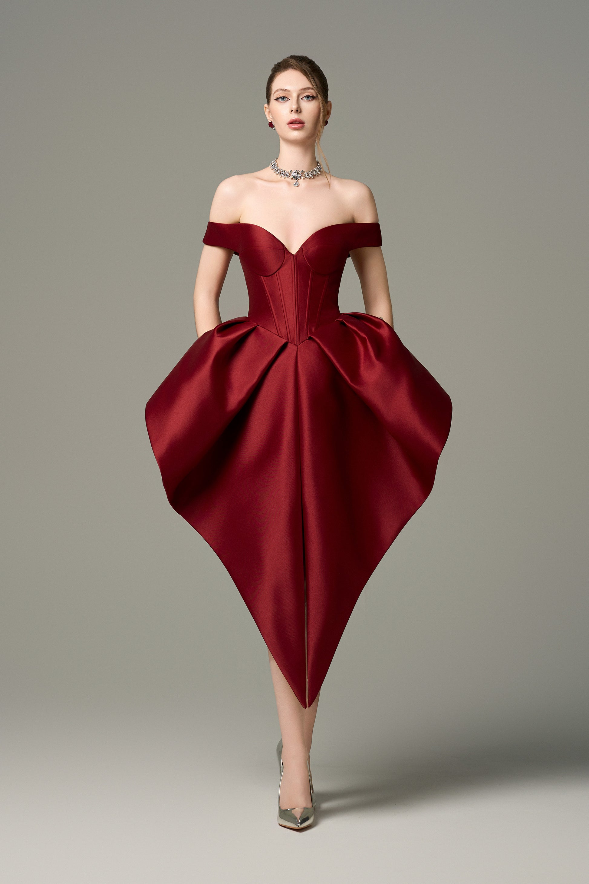 Off-the-shoulder sweetheart mini dress with structured bodice and skirt in deep red.