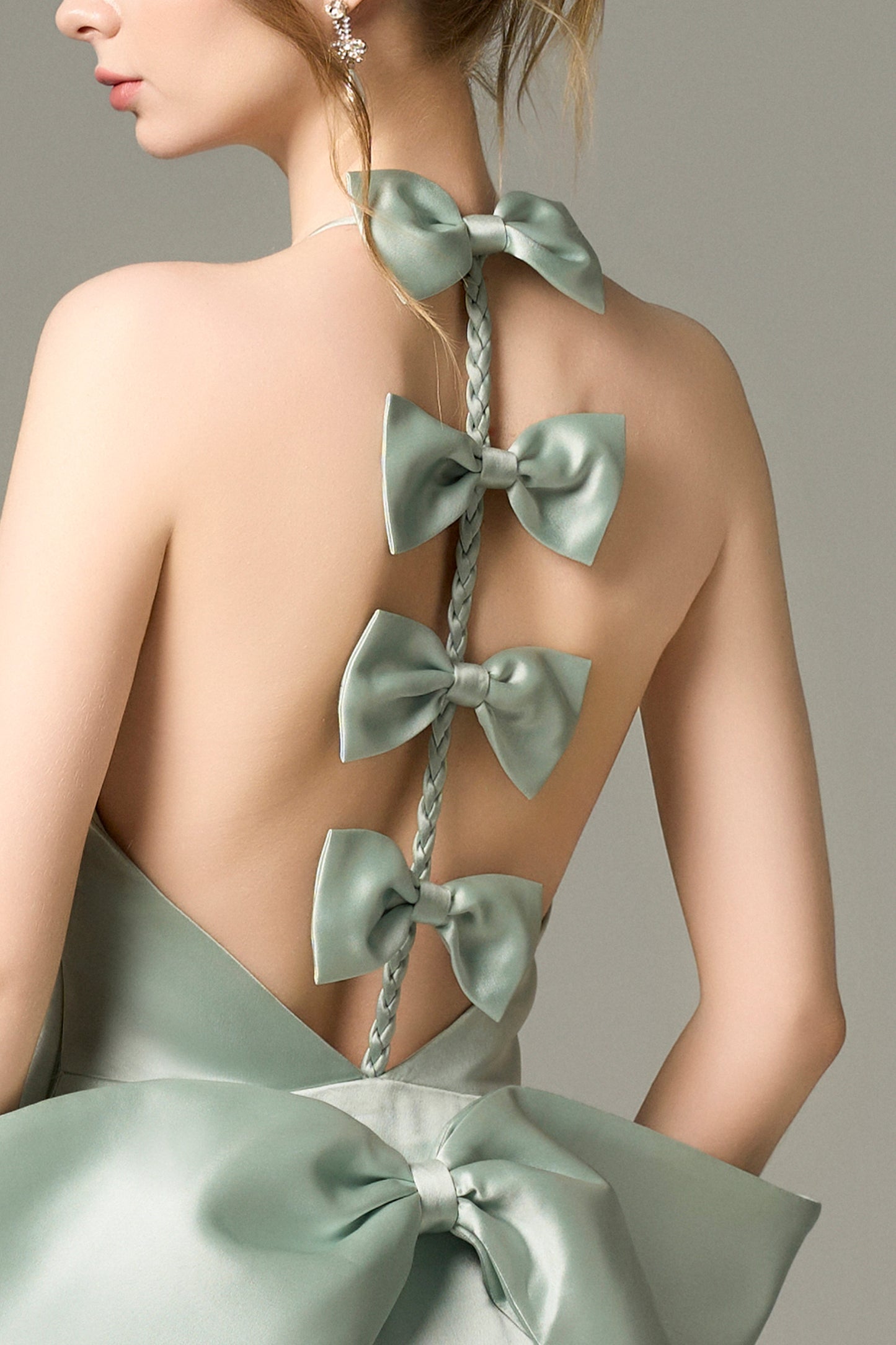 Turn heads in Light Green Silk Mini Dress, featuring a halter neckline, oversized bow, and crystal embellishments. 