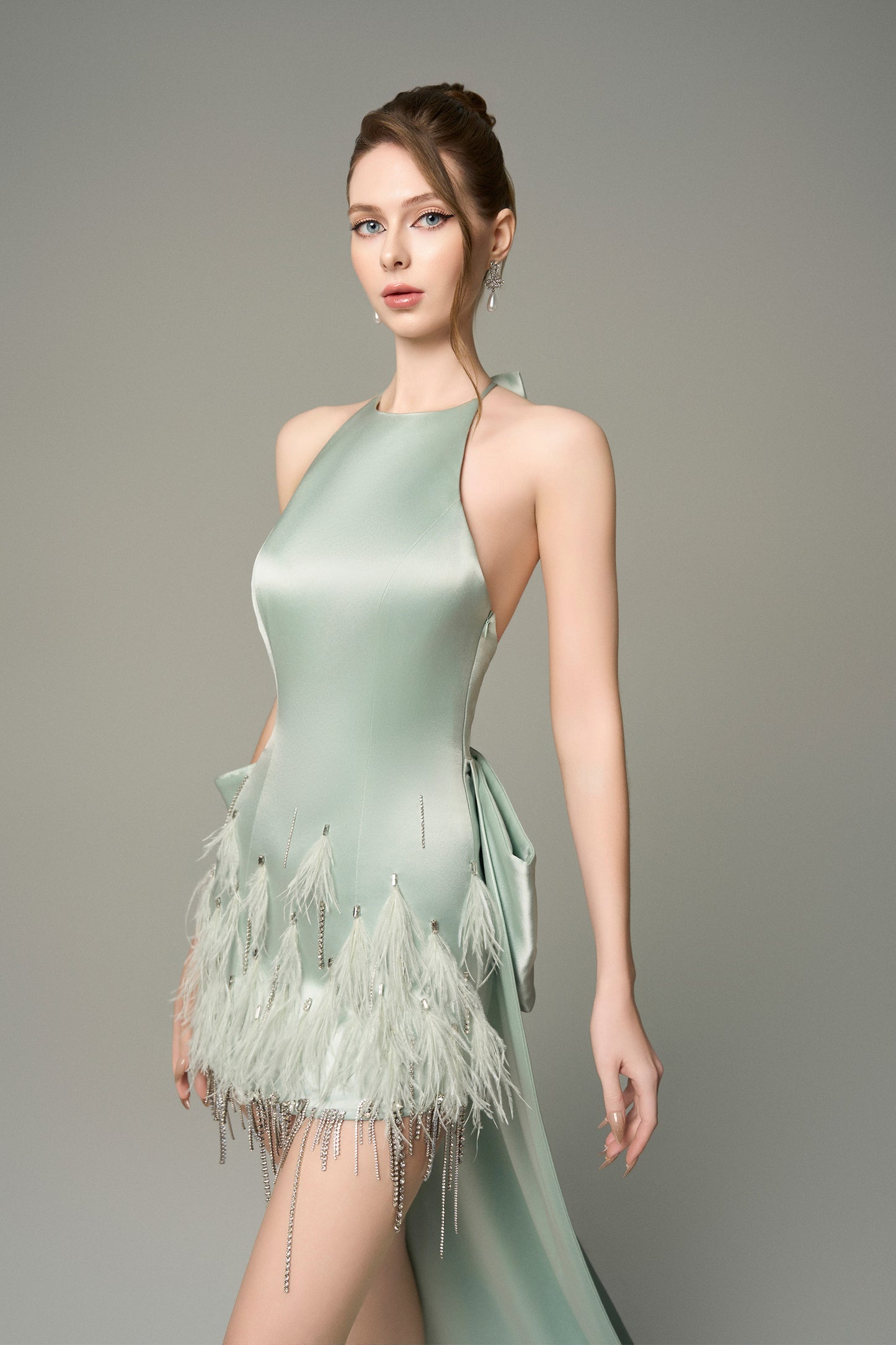 Turn heads in Light Green Silk Mini Dress, featuring a halter neckline, oversized bow, and crystal embellishments. 