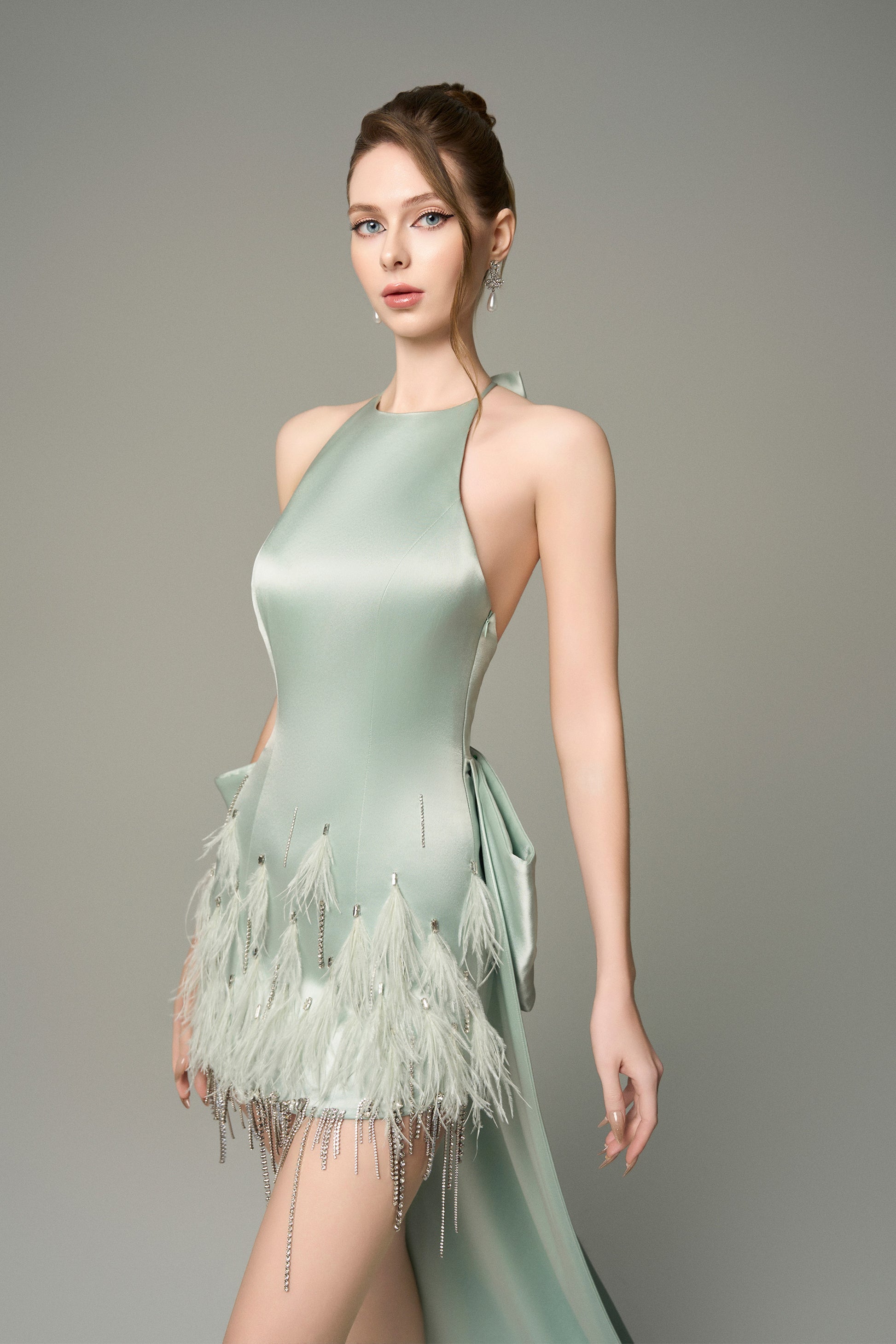 Turn heads in Light Green Silk Mini Dress, featuring a halter neckline, oversized bow, and crystal embellishments. 