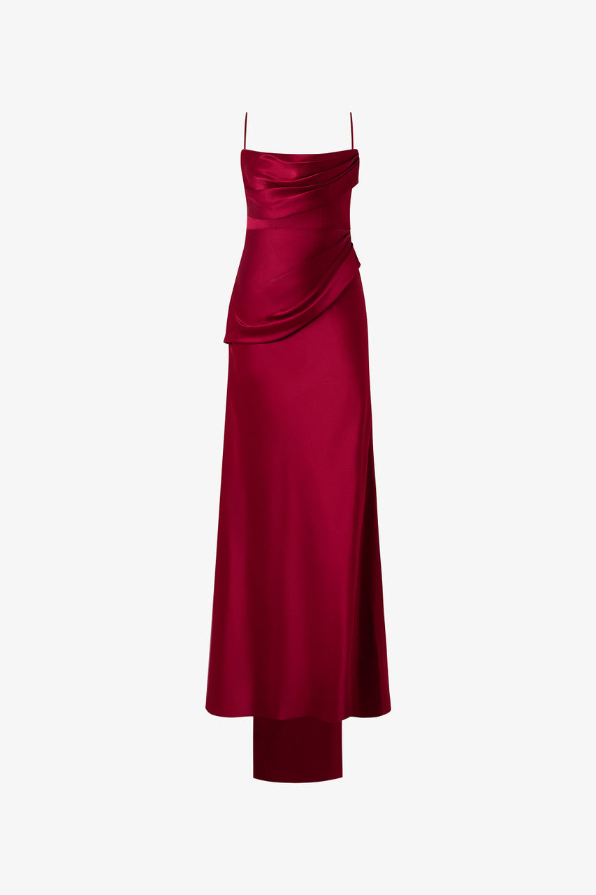 The red dress, adorned with soft pleats and ruffles, delicate spaghetti straps, intricate floral detailing and open-back design. 