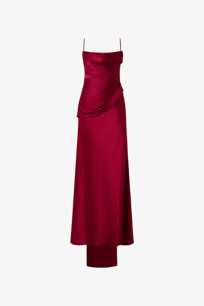 The red dress, adorned with soft pleats and ruffles, delicate spaghetti straps, intricate floral detailing and open-back design. 