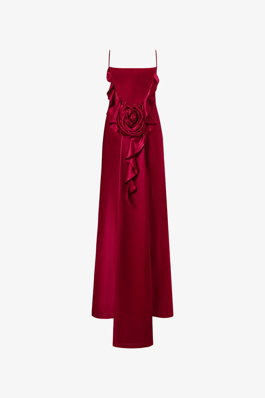 The red dress, adorned with soft pleats and ruffles, delicate spaghetti straps, intricate floral detailing and open-back design. 