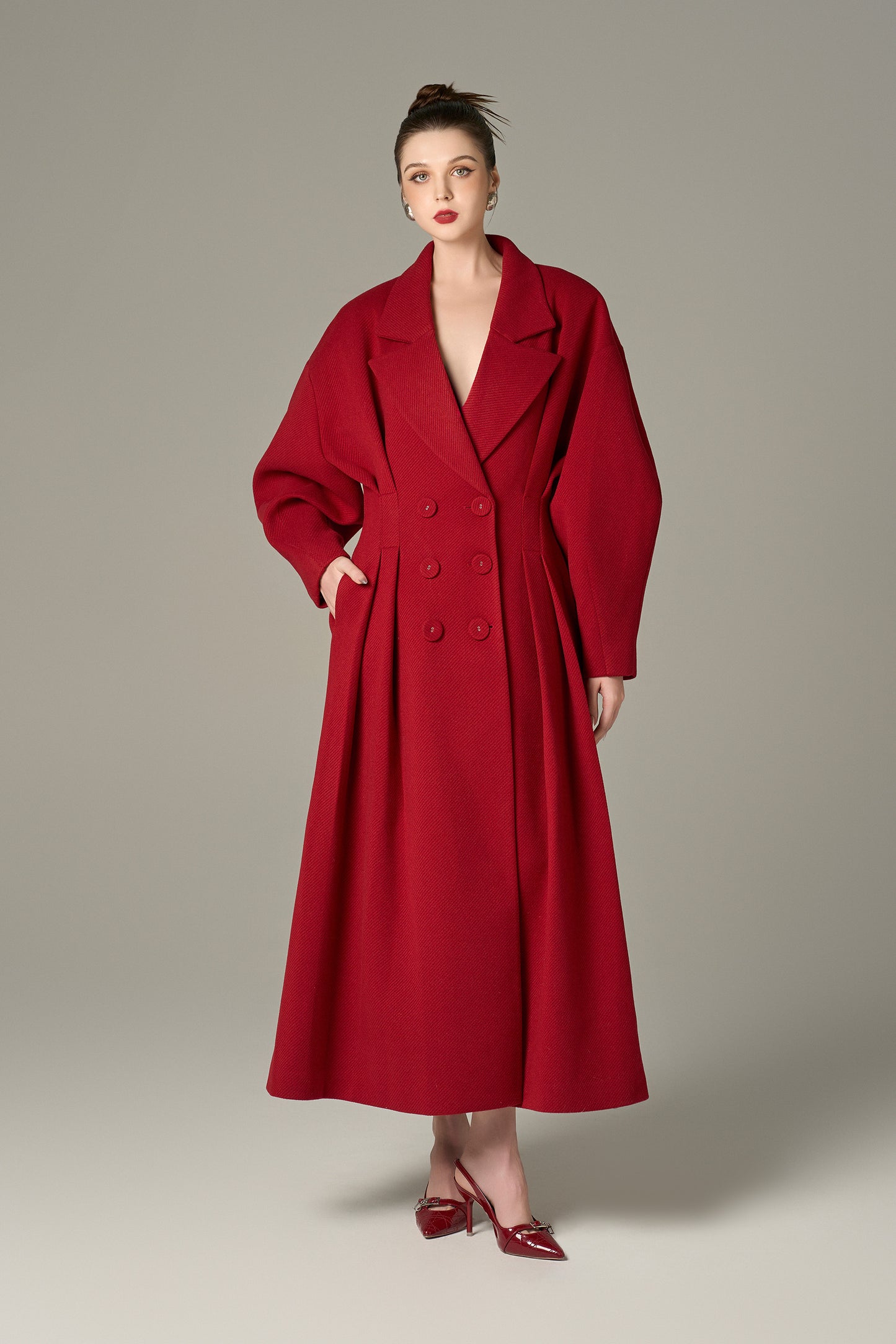 The Red Oversize Felt Texture Coat features a relaxed silhouette with a shawl collar and double-breasted front.