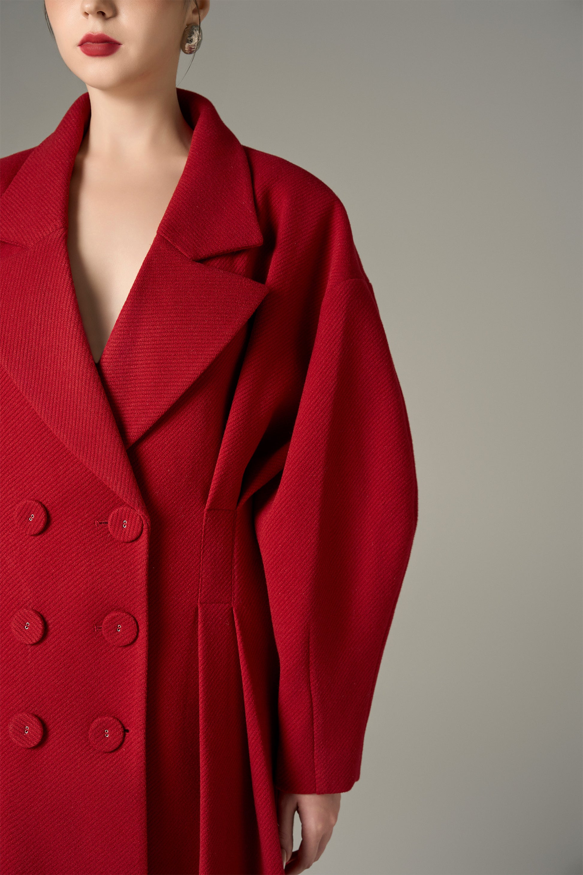 The Red Oversize Felt Texture Coat features a relaxed silhouette with a shawl collar and double-breasted front.