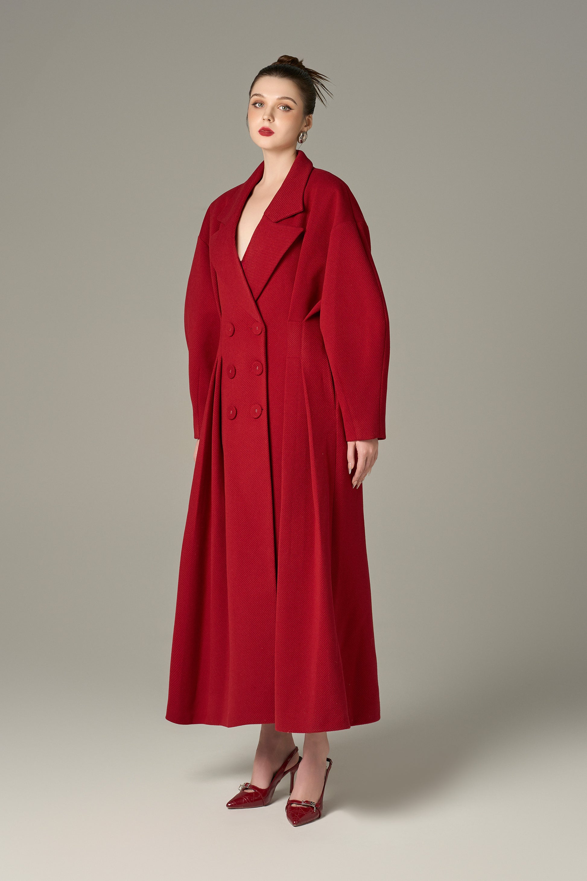 The Red Oversize Felt Texture Coat features a relaxed silhouette with a shawl collar and double-breasted front.