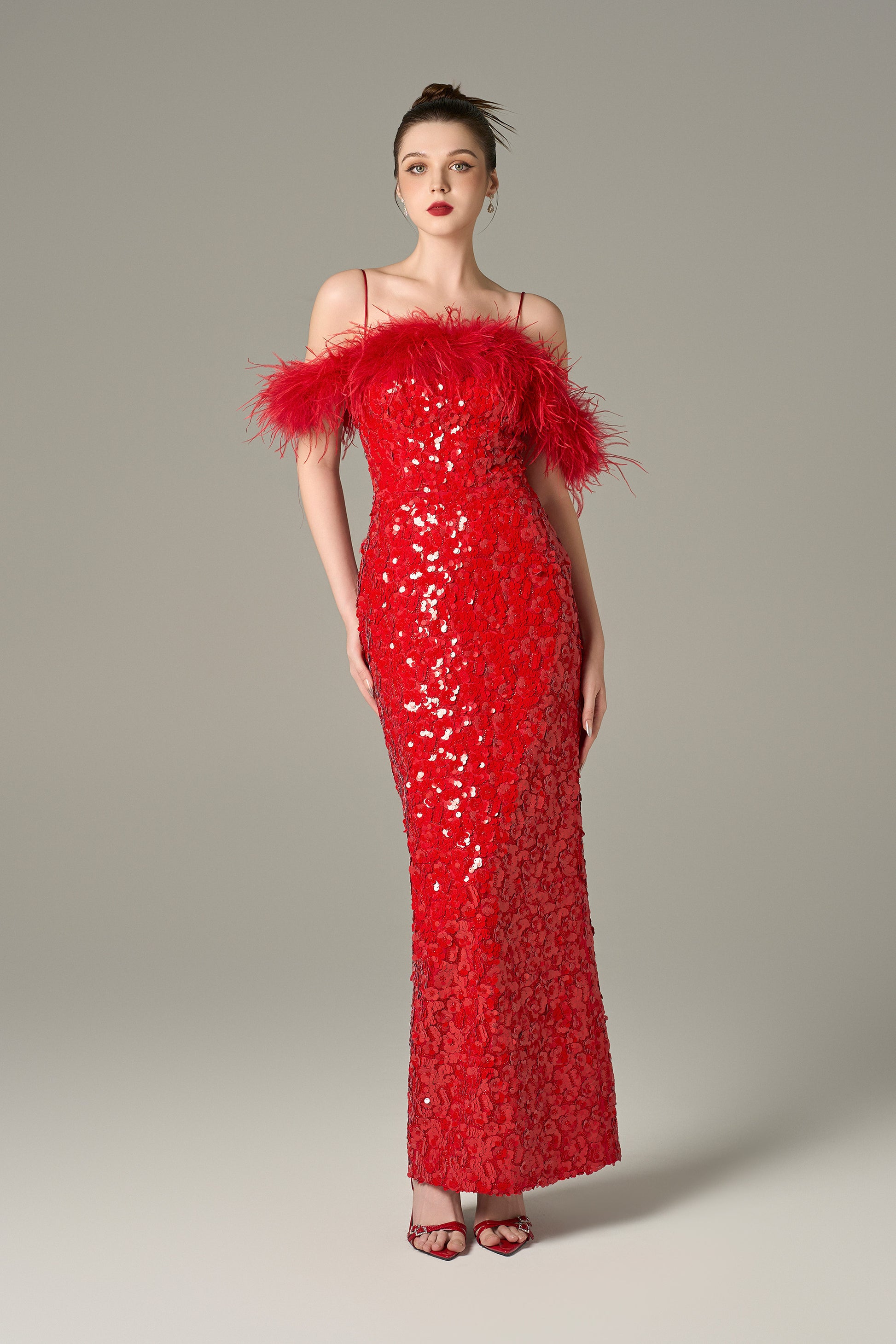 The Red Sequin Maxi Dress stuns with shimmering sequins and feathered shoulders.