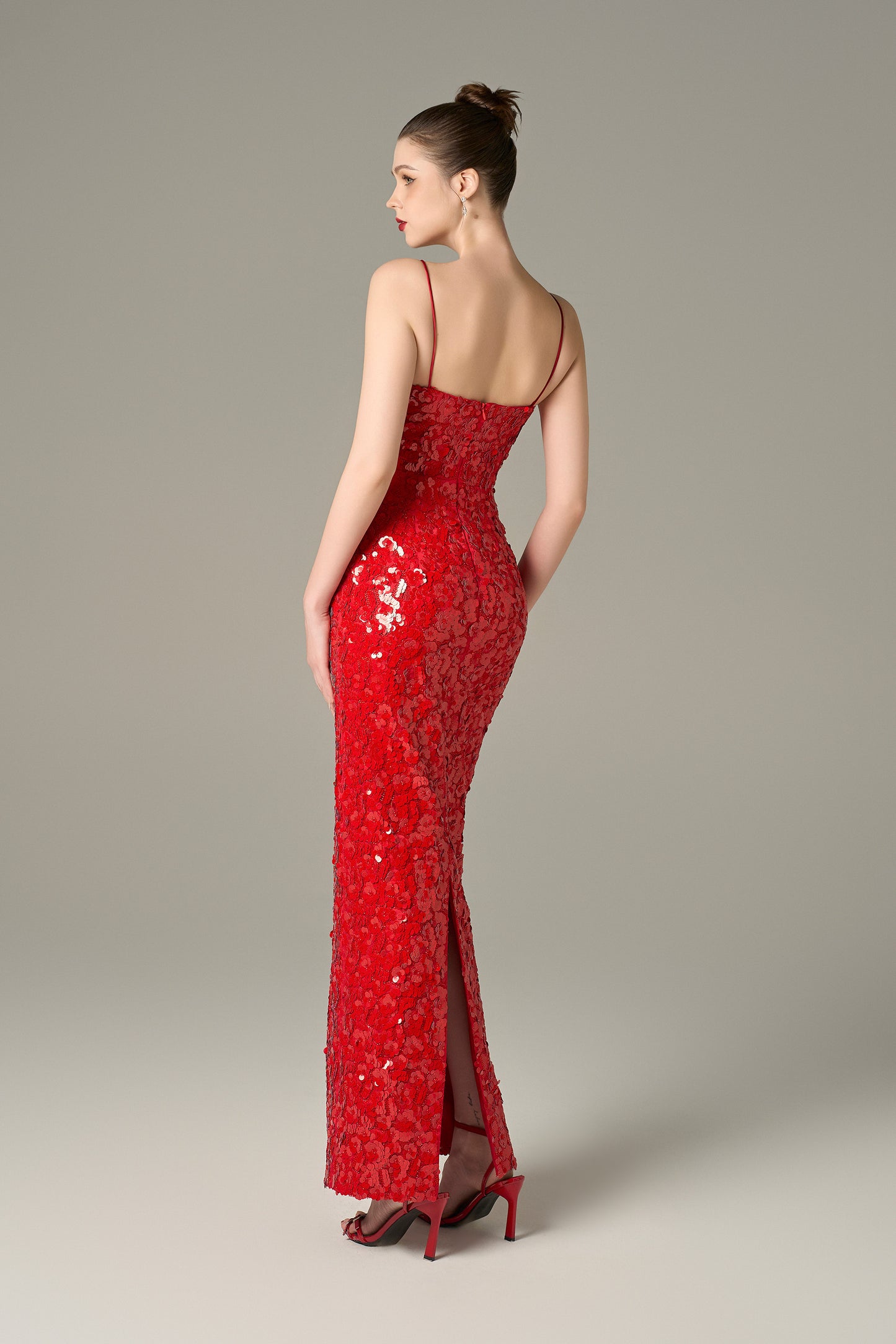 The Red Sequin Maxi Dress stuns with shimmering sequins and feathered shoulders.