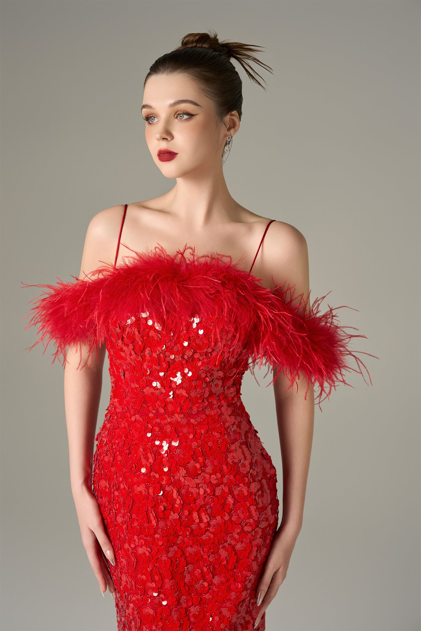 The Red Sequin Maxi Dress stuns with shimmering sequins and feathered shoulders.