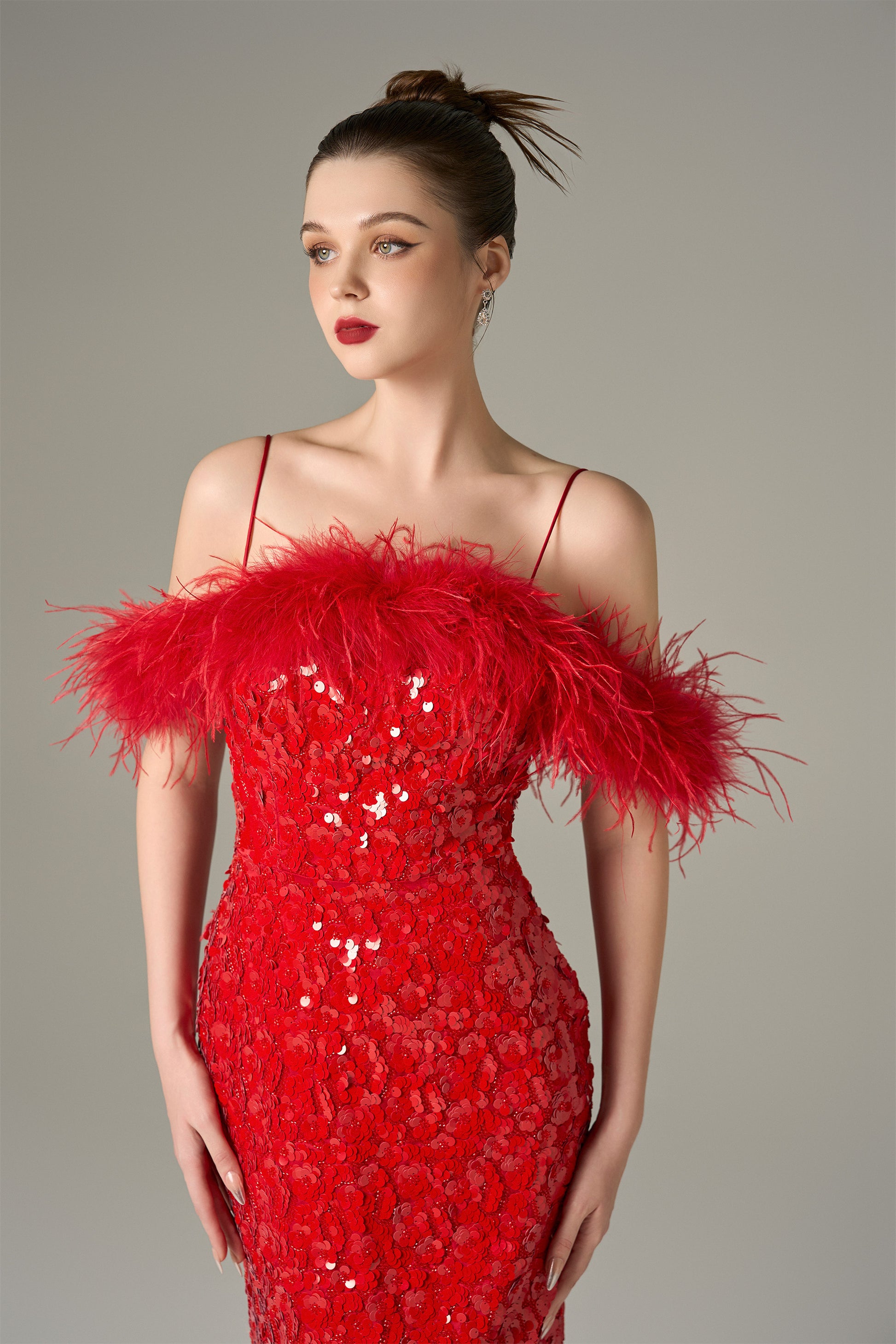 The Red Sequin Maxi Dress stuns with shimmering sequins and feathered shoulders.
