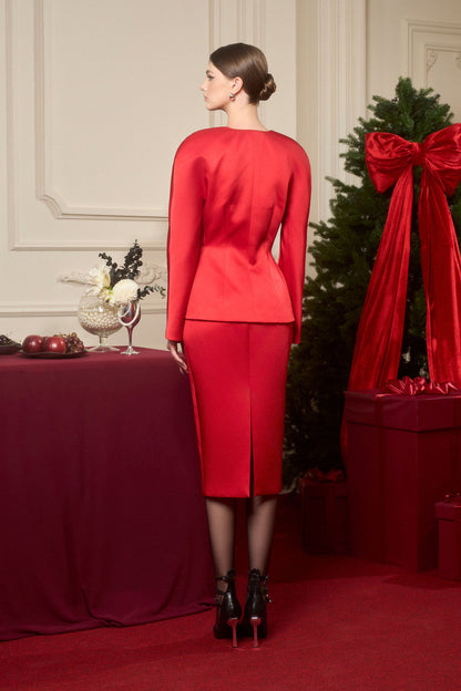 An red ensemble in taffeta, featuring a jacket with sequin floral embellishments and a high-waisted pencil skirt.