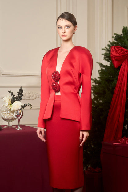 An red ensemble in taffeta, featuring a jacket with sequin floral embellishments and a high-waisted pencil skirt.
