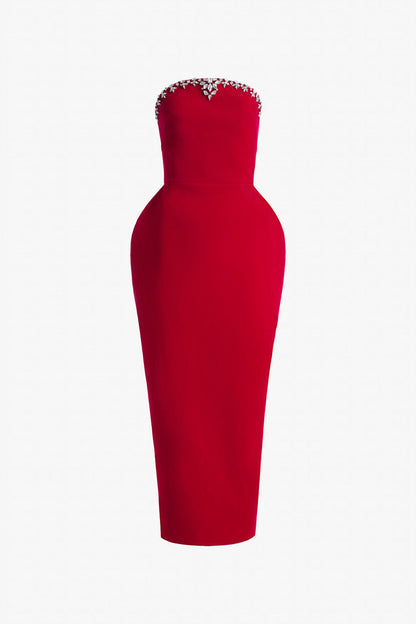 Red evening dress in velvet, with a bodycon silhouette, puff hips, and a dome-shaped neckline.