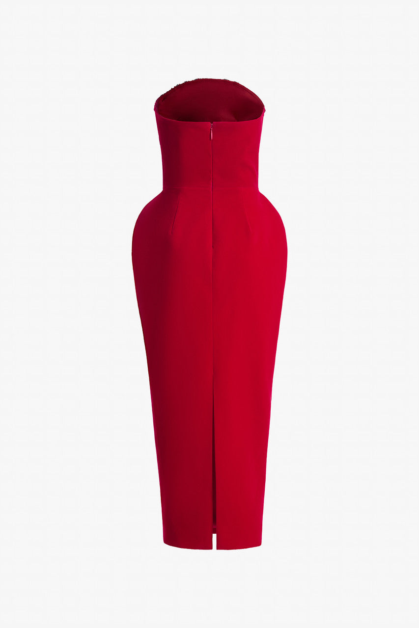 Red evening dress in velvet, with a bodycon silhouette, puff hips, and a dome-shaped neckline.