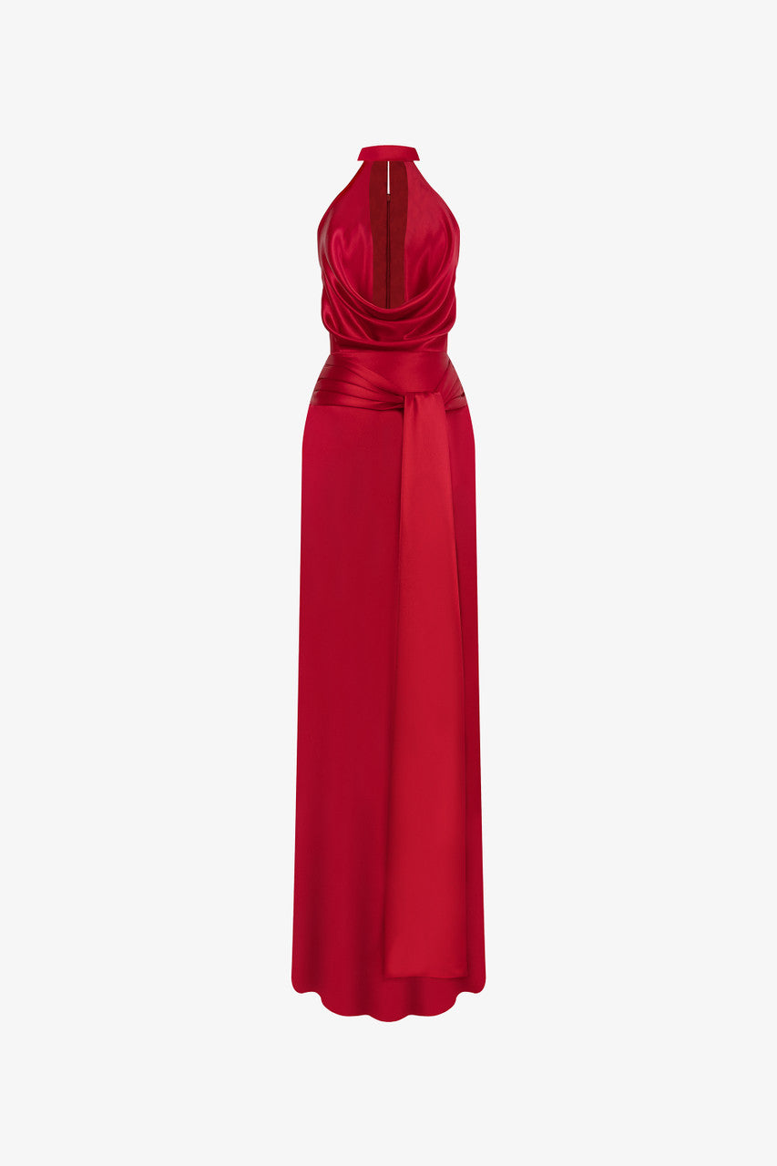 Red evening dress in silk with plunging neckline, sleeveless halter design.