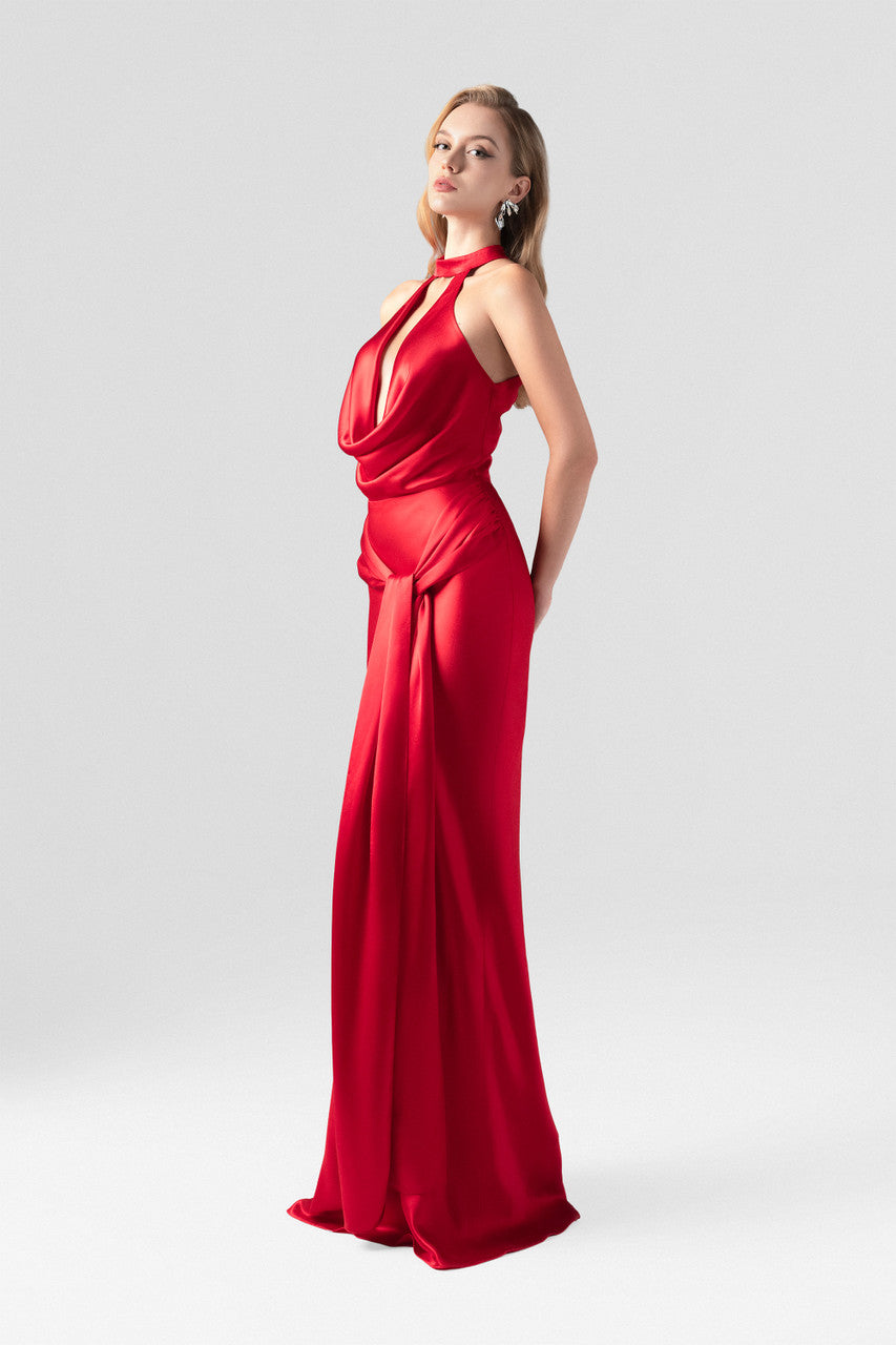 Red evening dress in silk with plunging neckline, sleeveless halter design.