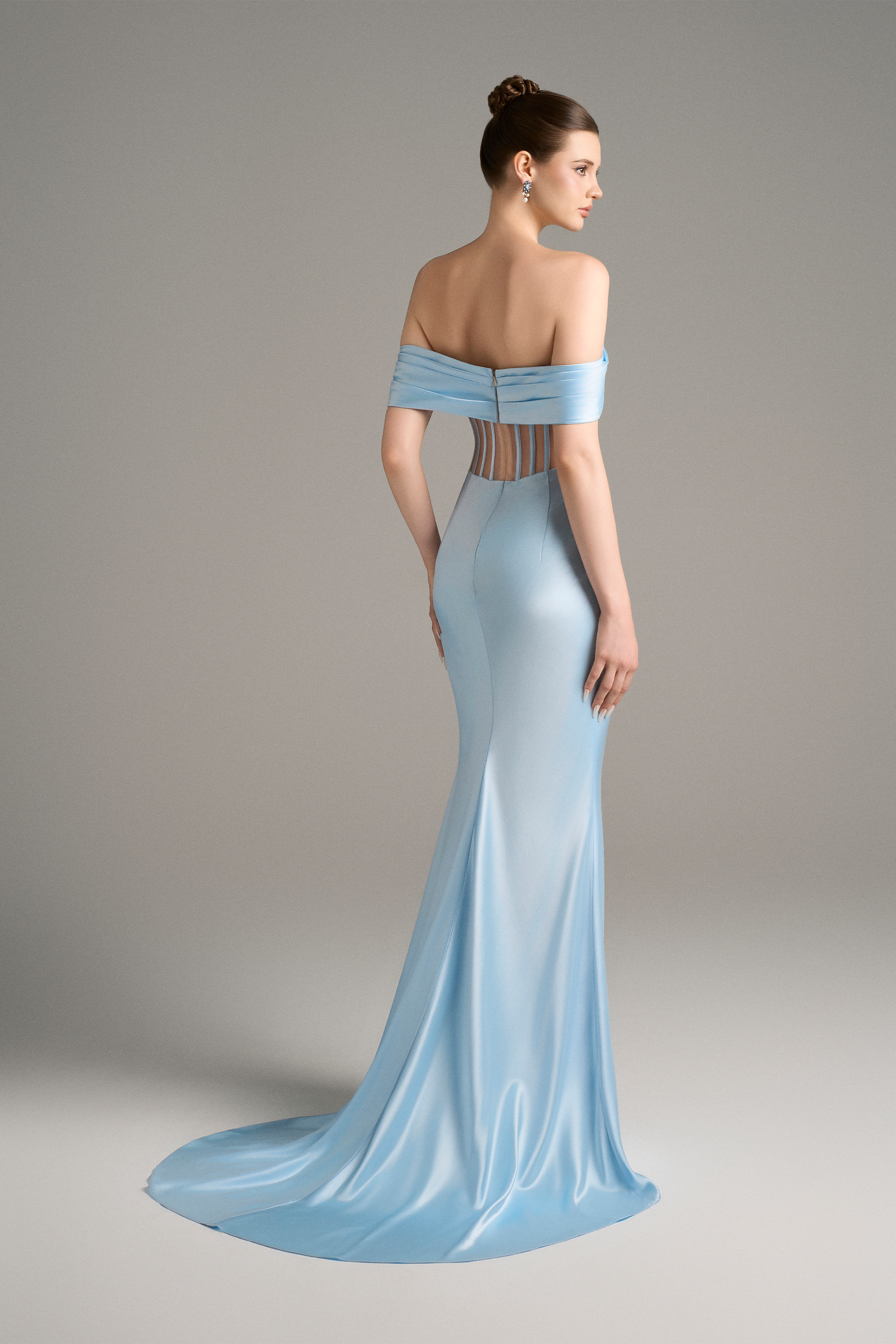 Side view showcasing the sculptural draping and graceful slit of the sky-blue off-shoulder corset gown.