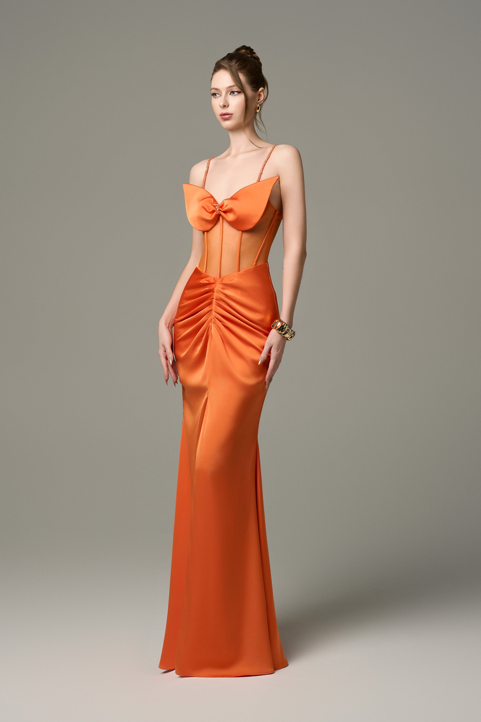 The Silk Mesh Corset Ruched Front Orange Gown with Crystals adorn the straps and bust. 
