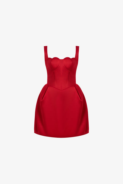 A red mini dress in taffeta, designed with a romantic heart-shaped neckline and puffed hips with structured pleats.