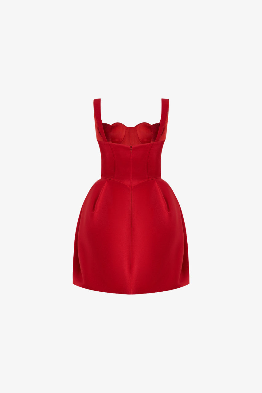 The back of the red dress has thick shoulder straps and a fitted bodice with a concealed zipper at the center.