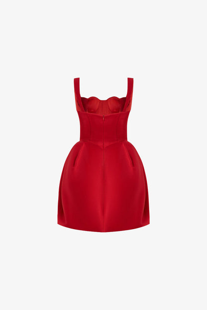 The back of the red dress has thick shoulder straps and a fitted bodice with a concealed zipper at the center.