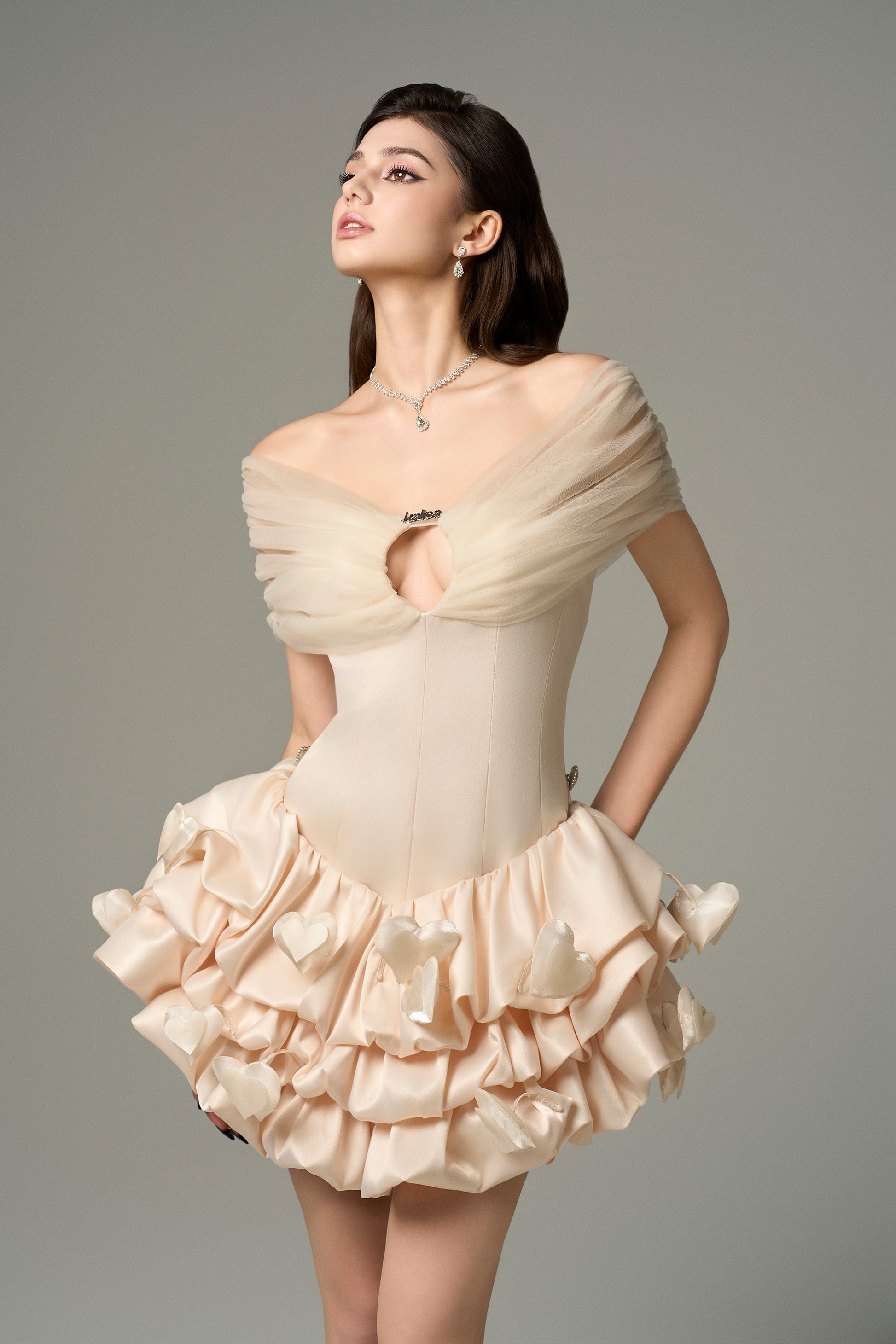Cream silk mini dress with bodycon fit, bold cutout at bust and puffy skirt.